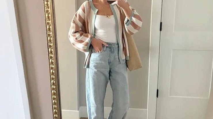 Woman wearing a striped knit cardigan over a simple top
