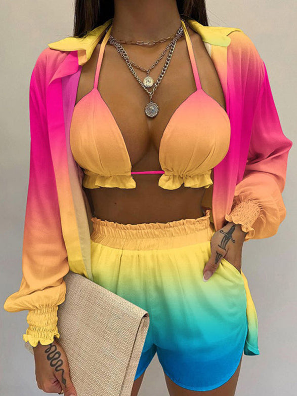 A model wearing a white long-sleeved shirt and matching shorts with a tropical print, paired with a white crop top.