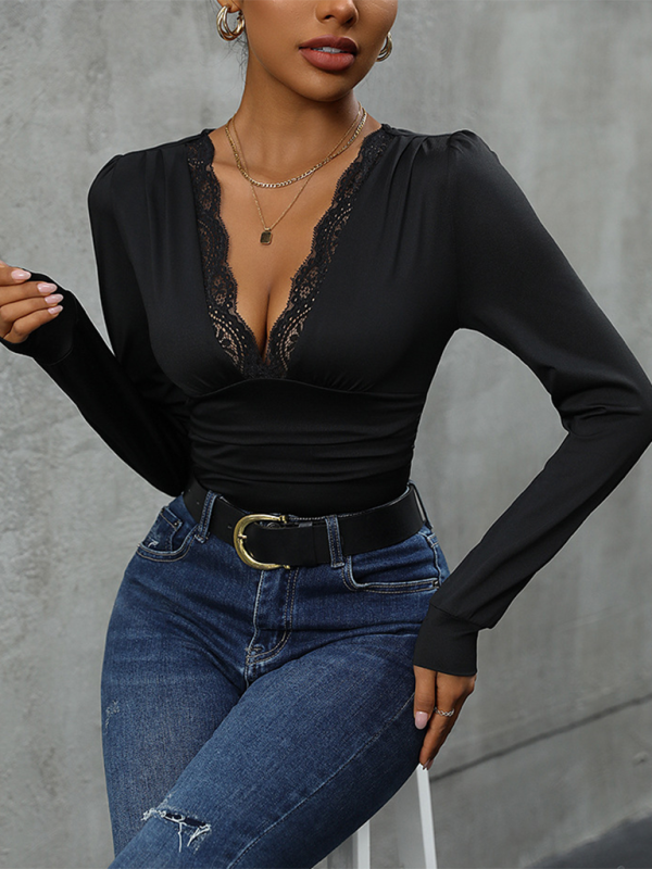 A woman wearing a black long sleeve bodysuit with lace detailing. Pairing with jeans and a belt.